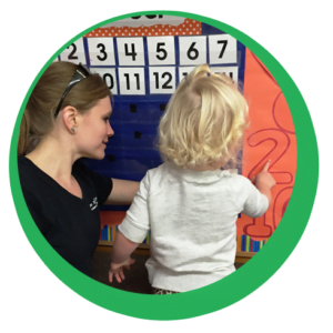 Teacher and child learning numbers and calendar at school teacher